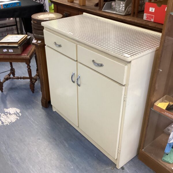 Cream vintage kitchen cabinet with Formica top.