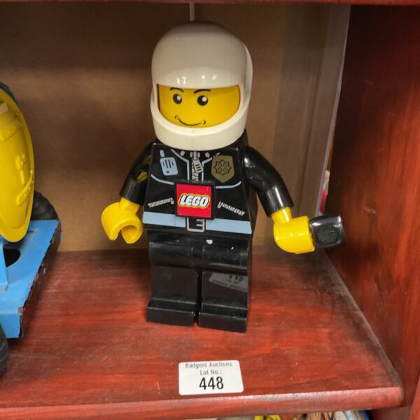 Vintage Lego policeman minifigure with flashlight accessory.