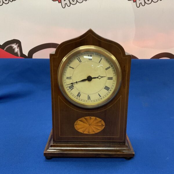 Antique inlaid mahogany mantle clock with a classic face.