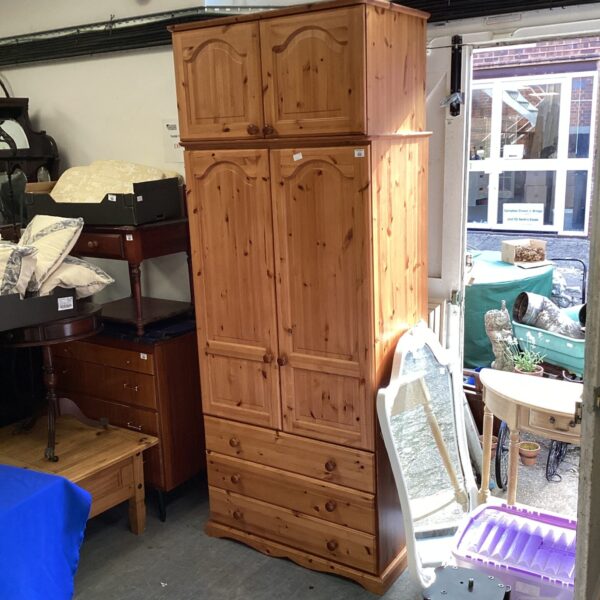 Vintage pine wardrobe with removable top for bedroom storage.
