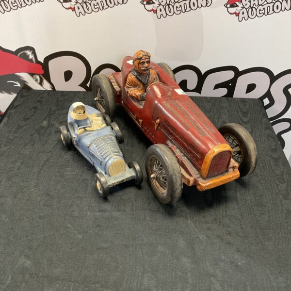 Vintage Bugatti pottery and fibreglass car models, collectible automobilia.