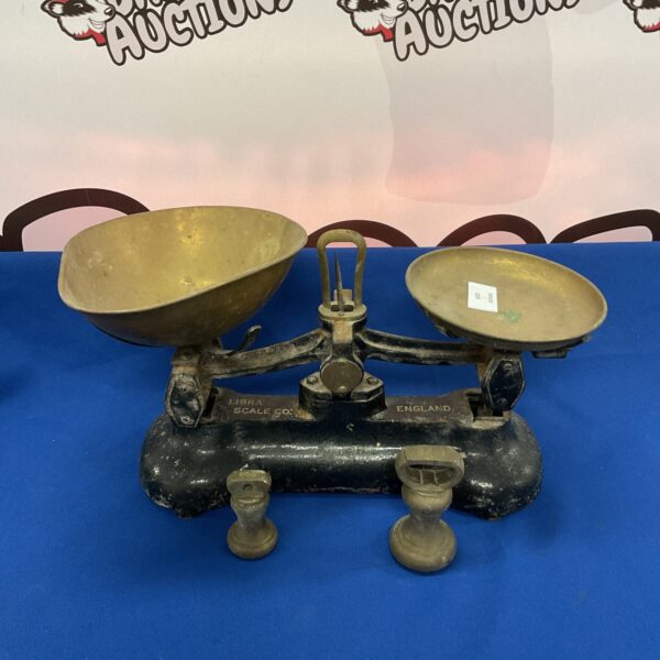 Vintage cast iron Libra scales with circular weighing pans.