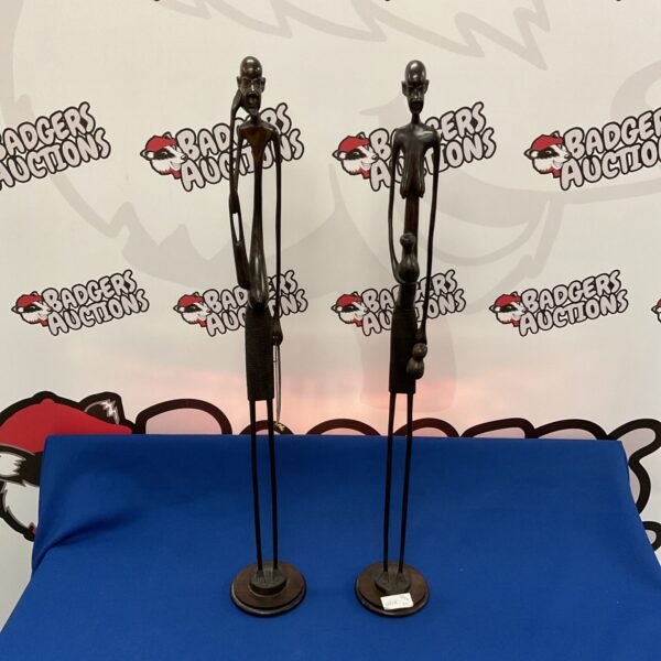 Pair of tall African tribal figures carved from dark hardwood.