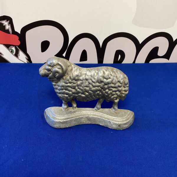 Vintage metal sheep door stop for farmhouse decor.