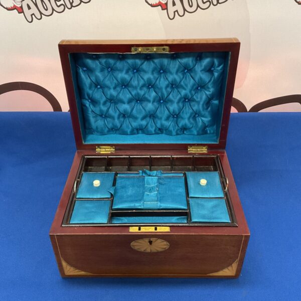 Vintage mahogany jewellery box with inlaid detailing and lined interior.