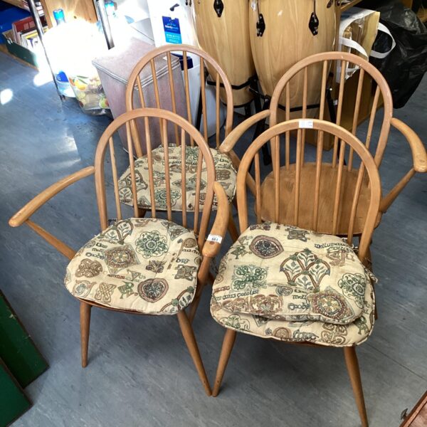 Vintage blonde wood Ercol stick back chairs in a home setting.