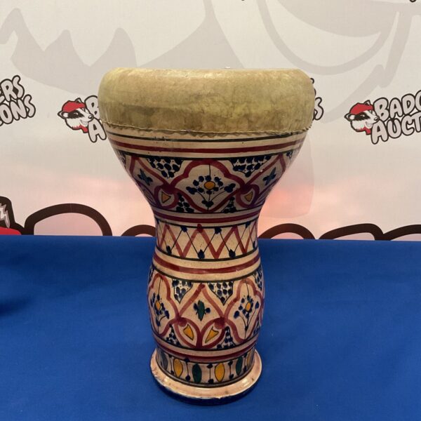 Vintage terracotta bongo drum with painted designs.