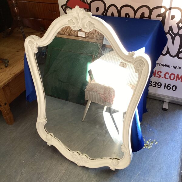 Large cream Rococo style mirror with ornate detailing.