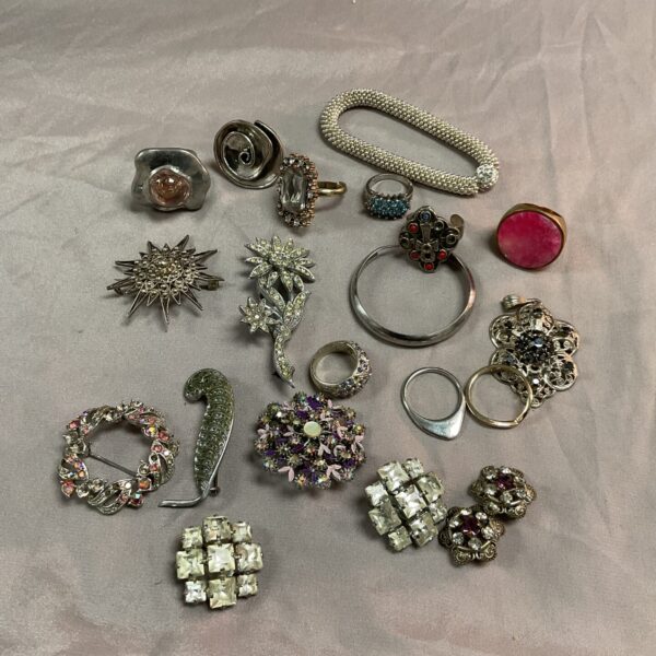 Vintage brooch collection lot with floral and geometric designs.