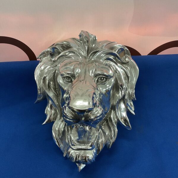 Detailed chrome lion head wall decor sculpture for home accent.