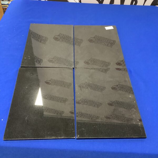 Set of four granite place mats for dining table protection.