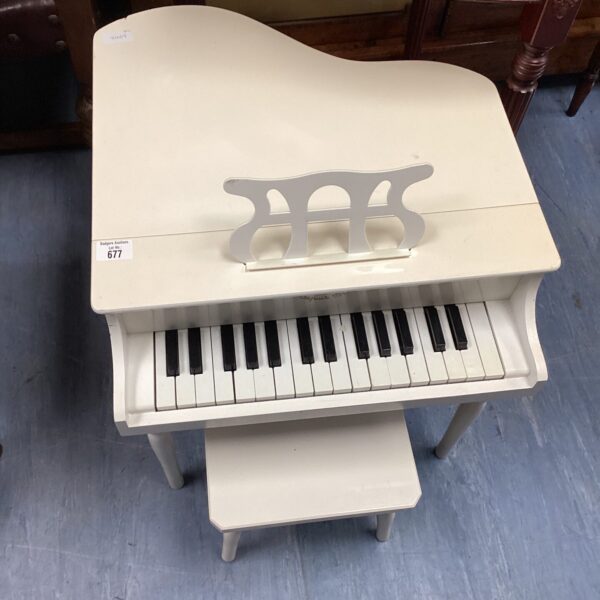 Vintage wooden child's piano with matching stool.