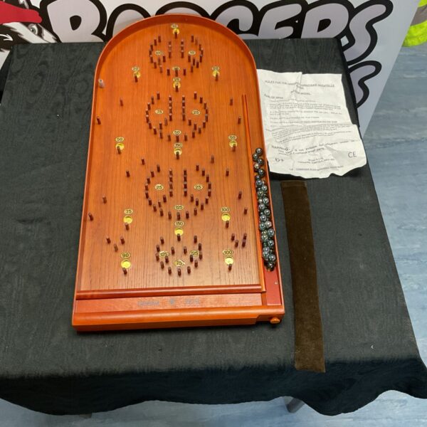 Vintage wooden Bagatelle board with numbered scoring areas for marble play.