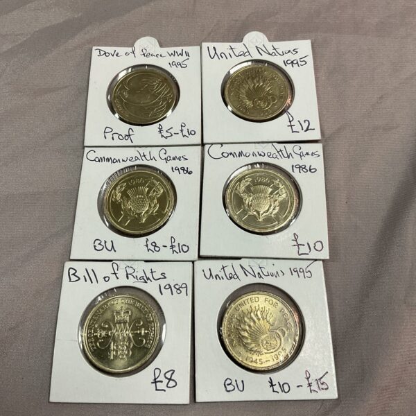 Lot of six uncirculated £2 coins, including Commonwealth Games coins.