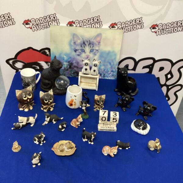 Vintage cat figurine collection on display, porcelain animals.