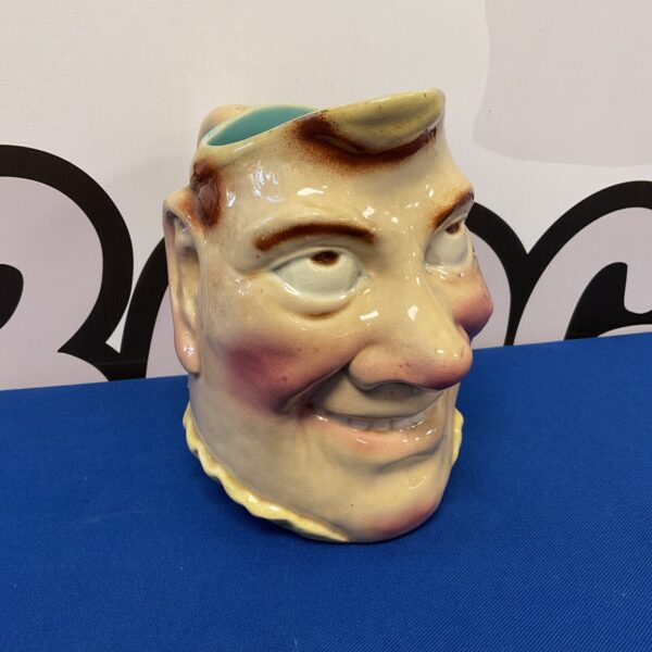 Antique Sarreguemines majolica character jug, detailed facial features.