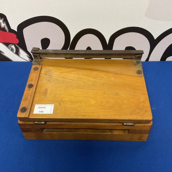 Vintage Merretts paper guillotine, a classic desk-top paper cutter.