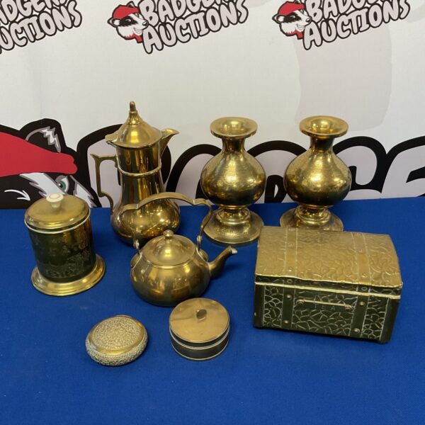 Vintage brassware collection featuring a tea chest and trinket pots.
