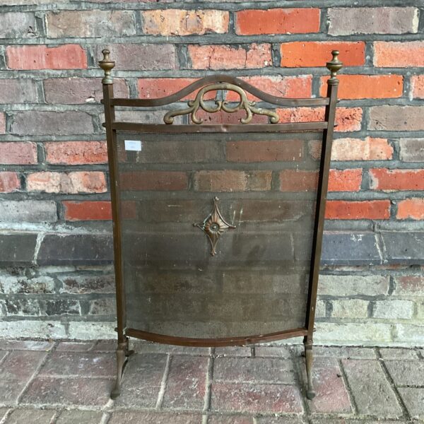 Antique copper and brass fire screen with decorative pierced panel.