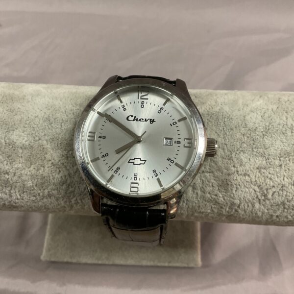 Front view of a vintage Chevy quartz wristwatch with leather strap.