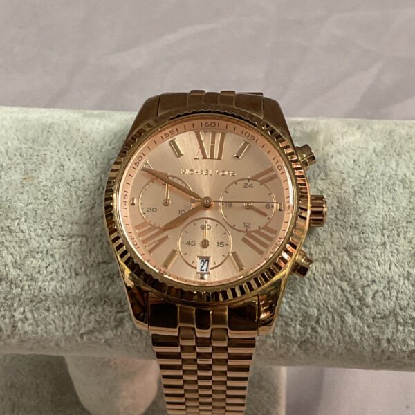 Gold-tone Michael Kors wristwatch with detailed face and bracelet.