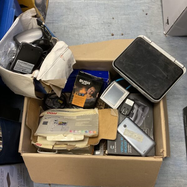 Mixed electrical lot with VR headset and digital camera visible.