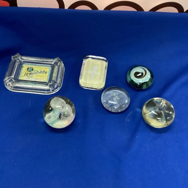 Vintage glass paperweight collection with ash tray.
