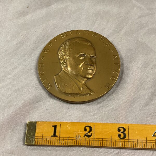 Bronze medal featuring Richard Nixon portrait, collectible political memorabilia.