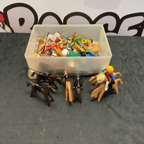 Vintage Playmobile figures and accessories in a clear box.