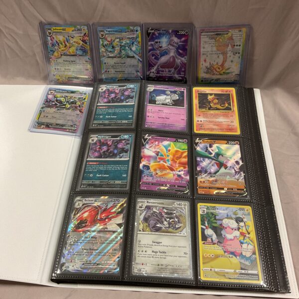 Pokemon card binder with holographic cards visible.