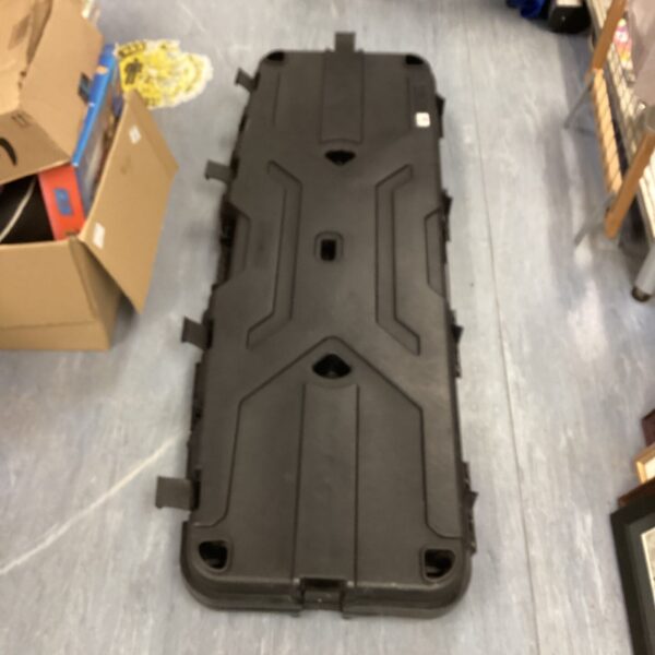 Black Pillarlock gun case open on a grey floor.