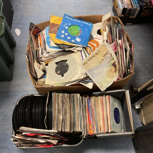 Large collection of vintage 7 inch vinyl records for collectors.