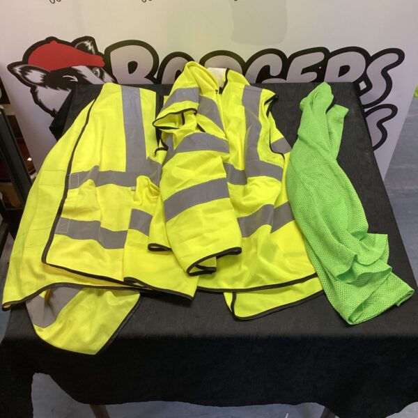 Lot of four yellow hi visibility vests for safety.