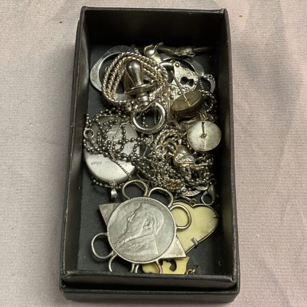 Mixed silver jewellery lot with chains and pendants.