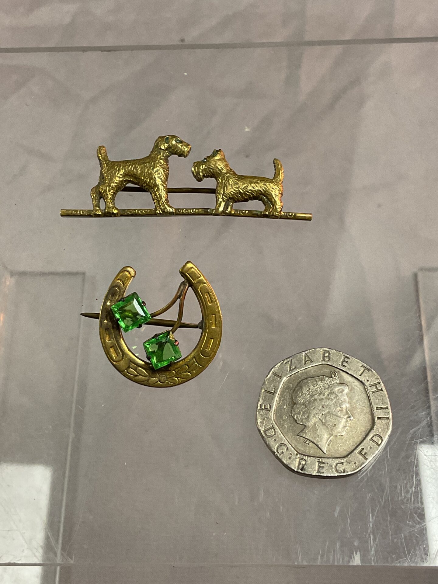 909 horseshoe brooch set with green stones and two dogs brooch