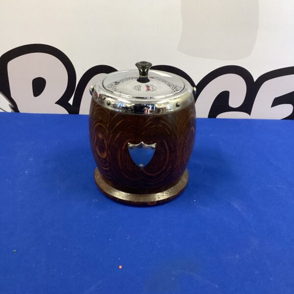 Vintage oak biscuit barrel with ceramic lid and shield inlay.