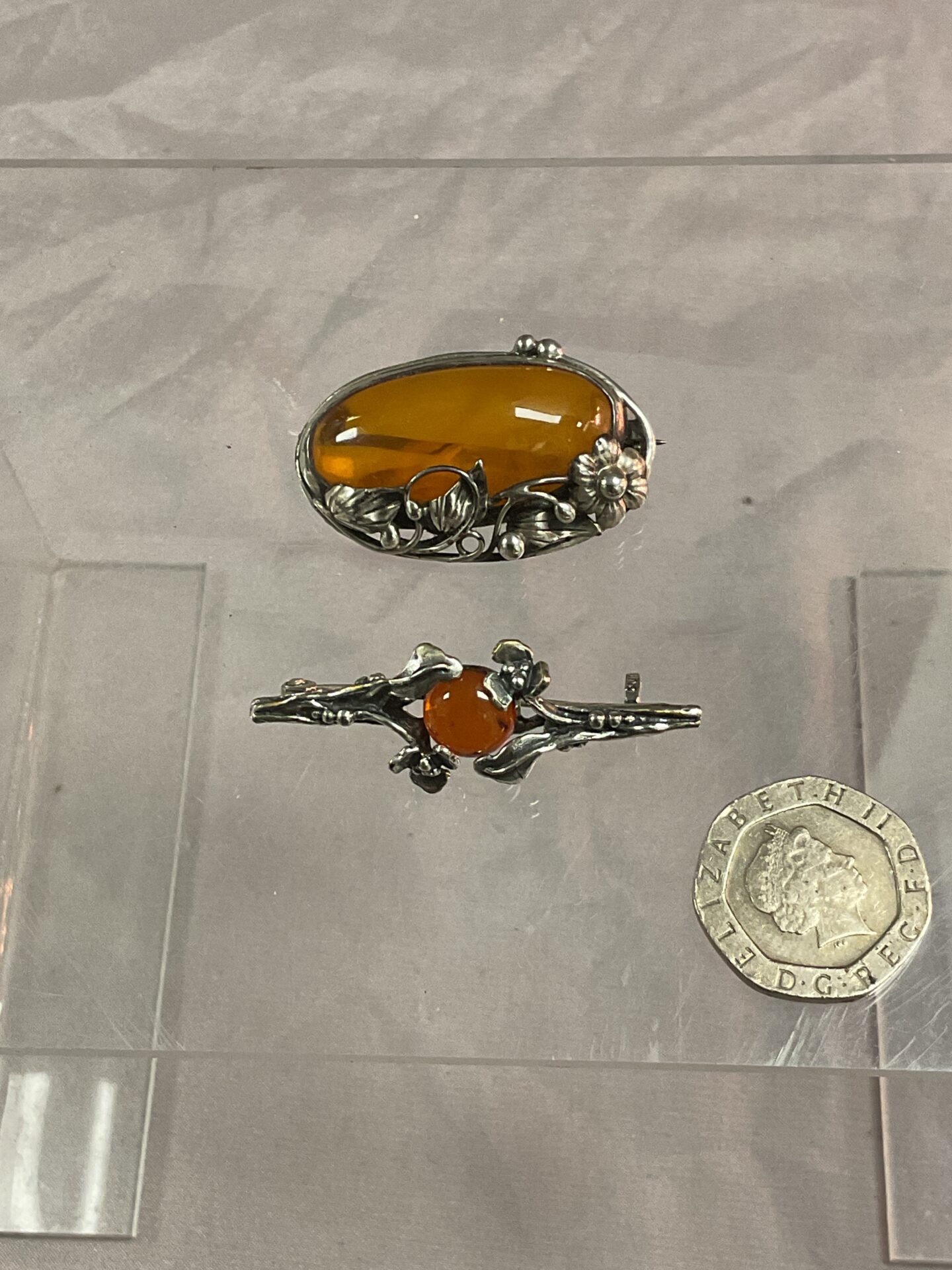 911 Two silver art nouveau amber brooches