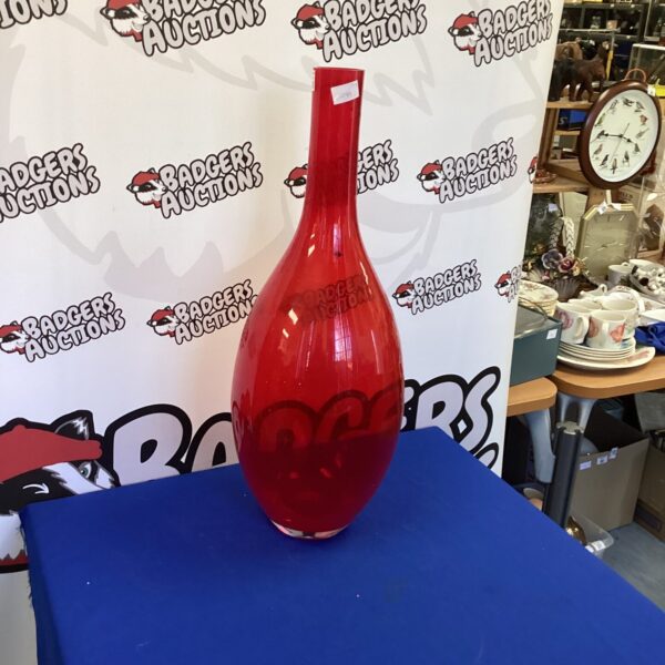 Large red glass vase, a striking home decor accent.