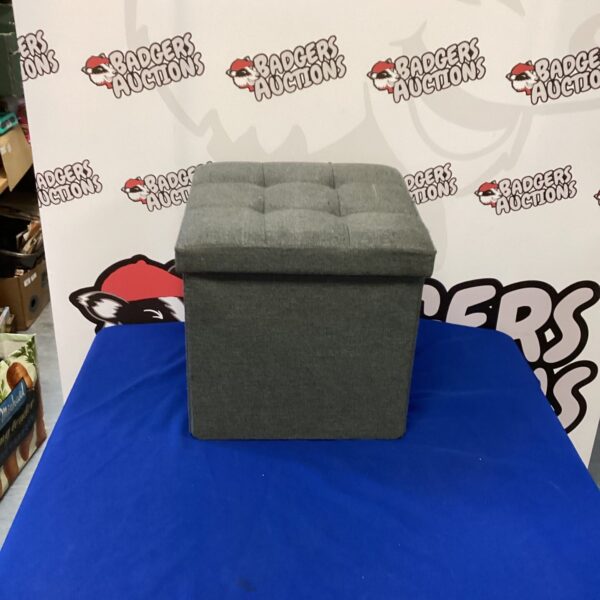 Grey padded storage box for home organisation and seating.