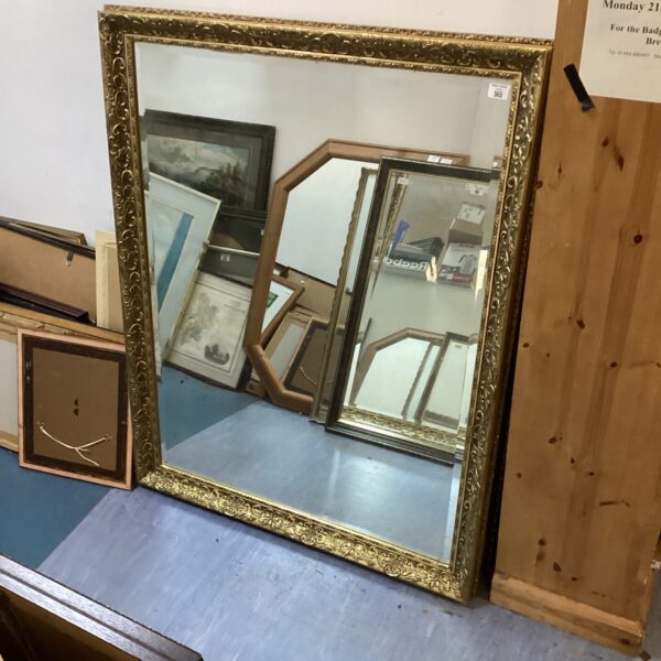 Elegant gilt framed bevel edged mirror for wall decoration.
