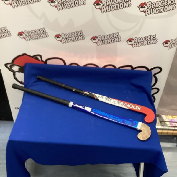 Pair of vintage hockey sticks including a Kookaburra model.