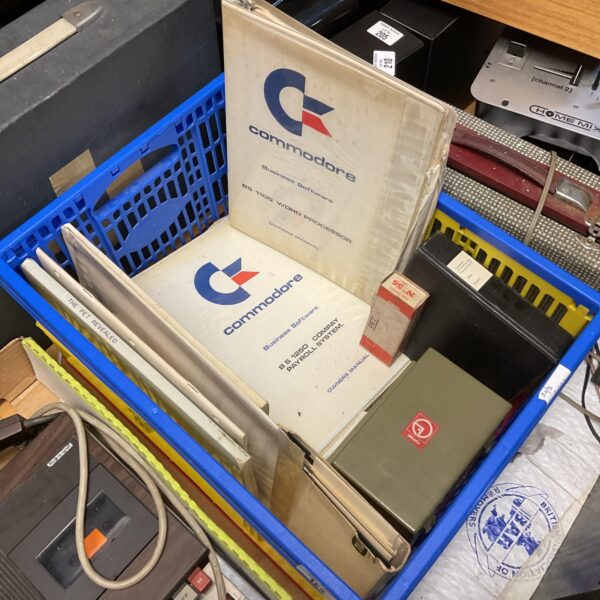 Vintage Commodore Pet manuals and floppy discs in a box.