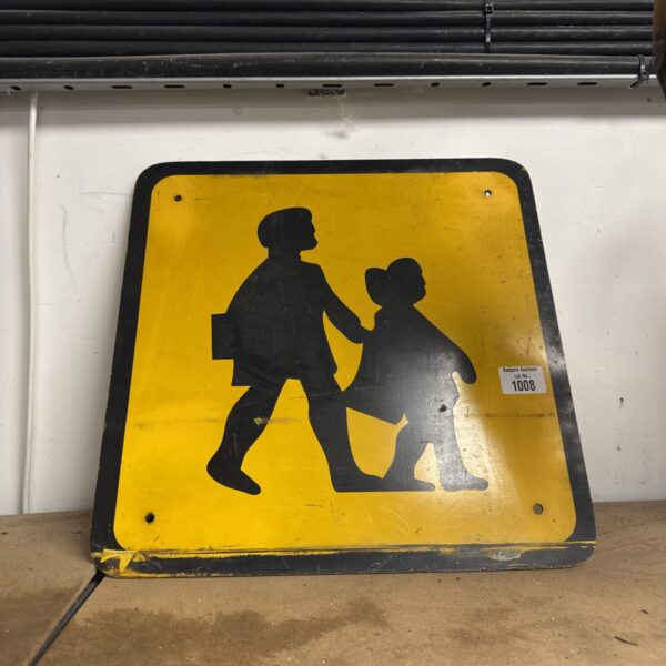 Vintage plastic school crossing sign with children figures.