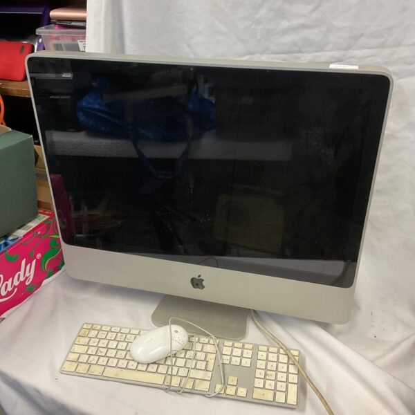 Vintage Apple iMac G4 computer with keyboard and mouse.