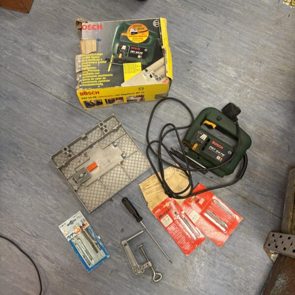 Bosch PST 54 PE corded jigsaw with accessories and spare blades.