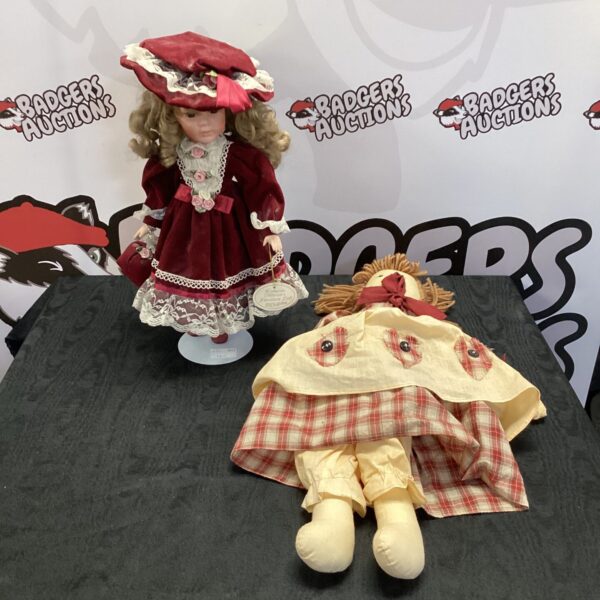 Leonardo Collection porcelain doll with vintage rag doll style.