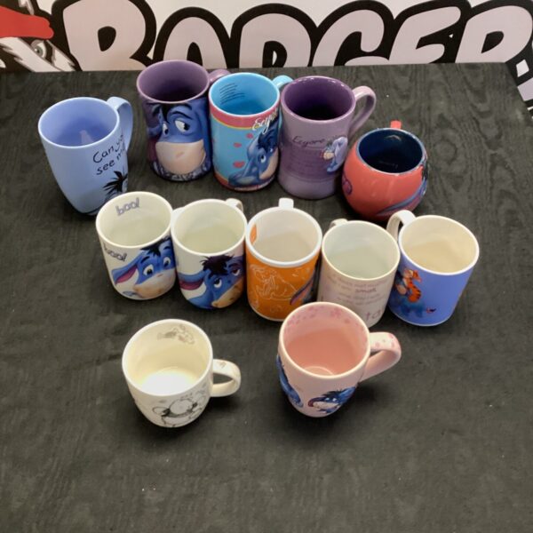 Collection of Eeyore mugs from Winnie the Pooh.