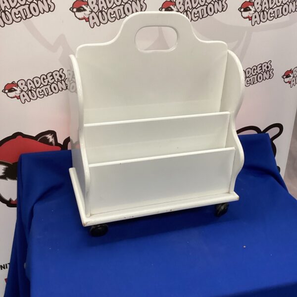 Vintage white wooden magazine rack for organizing magazines and documents.