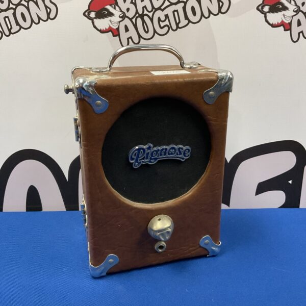 Vintage Pignose portable guitar amplifier, side view.