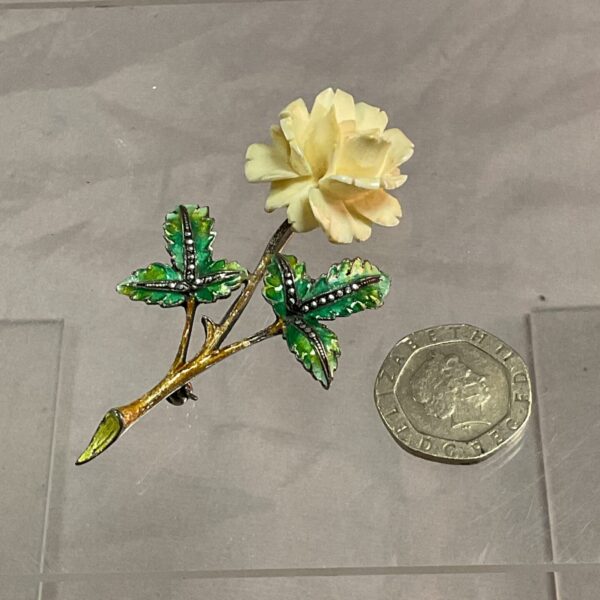 Vintage silver and marcasite rose brooch with green enamel leaves.